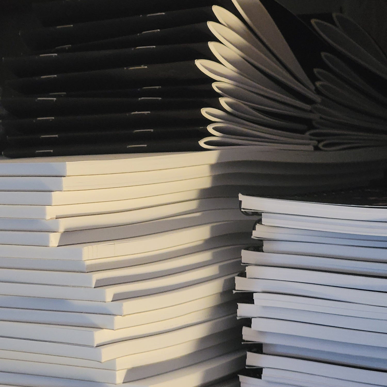 Photographie de plusieurs piles de carnets et bloc-notes